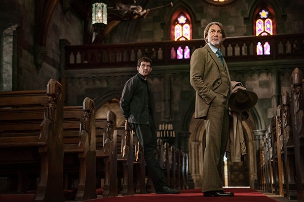 two men standing in a church