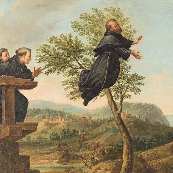 A man in black robes levitates near a tree while two men watch from a wooden platform.