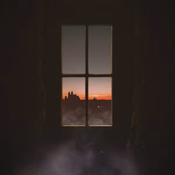Silhouetted city skyline at sunset seen through a four-pane window with mist inside the room.