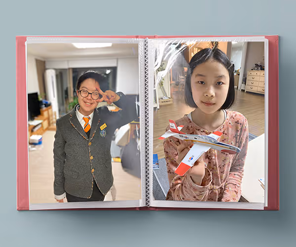 photos of Yusang and Seoyul in a small photo album