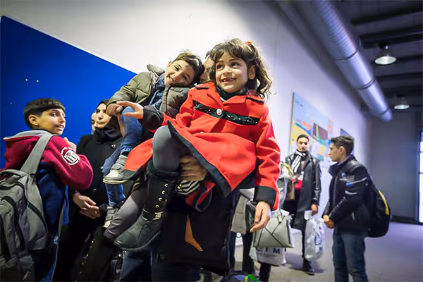 A Syrian father and his children wait in line to have their passports checked at Hanover airport in Germany.