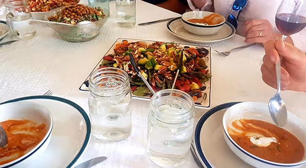 people eating soup and salad