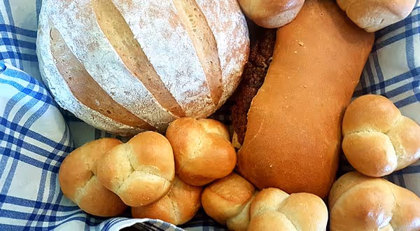 different types of bread on a blue checked cloth
