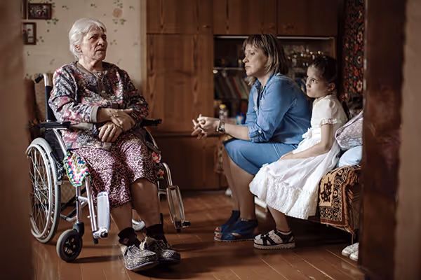 Alla Lutskevich and her daughter visiting a parishioner