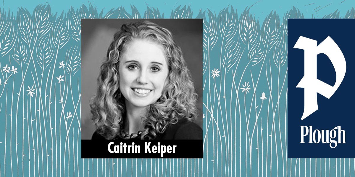 Black and white portrait of a smiling woman with curly hair labeled Caitrin Keiper.