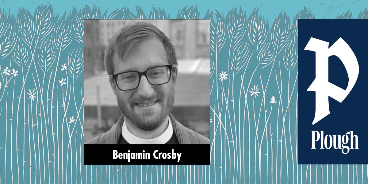 Smiling man with glasses and beard, labeled Benjamin Crosby, on a blue background with white wheat illustrations.