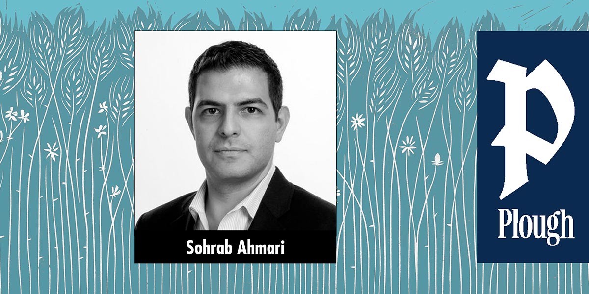 Black and white headshot of a man in a suit against a stylized blue wheat field background with a Plough logo.