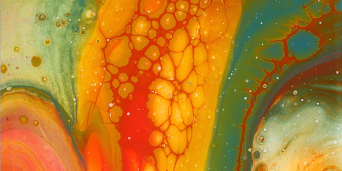 Abstract colorful fluid art with orange, red, green, and yellow hues and bubble-like patterns.