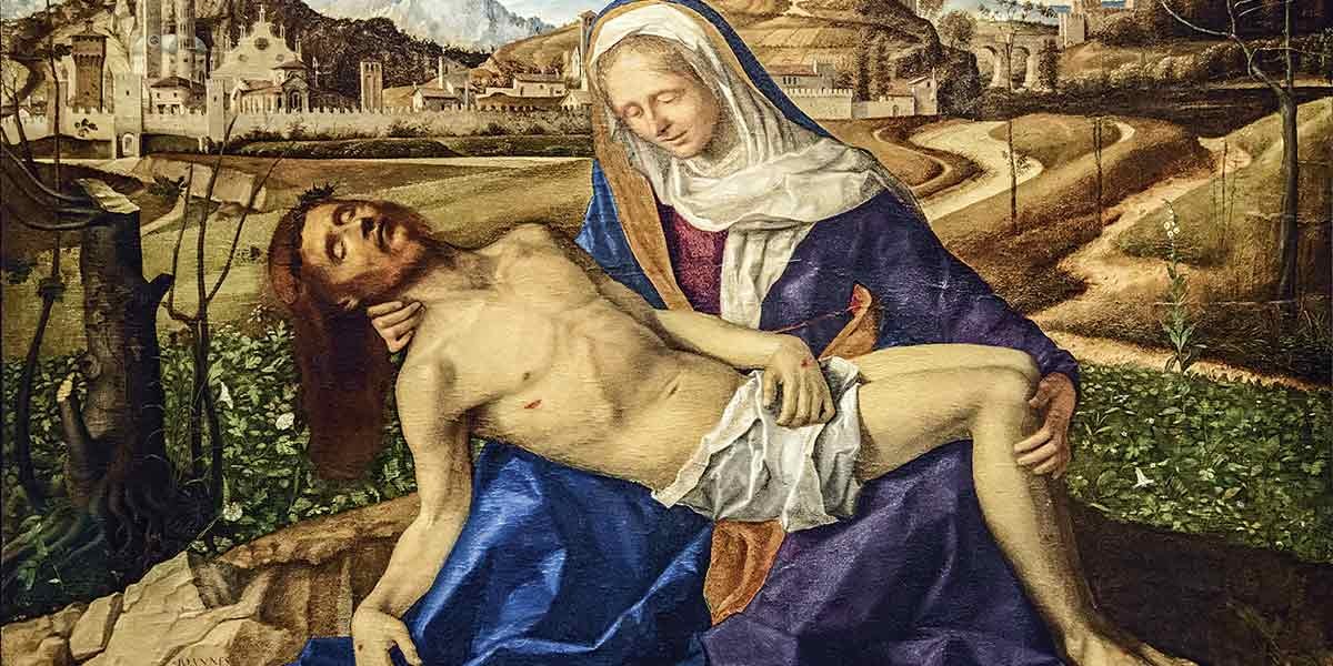 Painting of Mary cradling the deceased Jesus in a landscape with buildings and mountains in the background.
