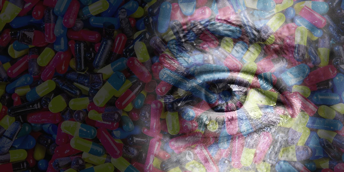 Close-up of a human eye overlaid with colorful capsules and pills in the background.