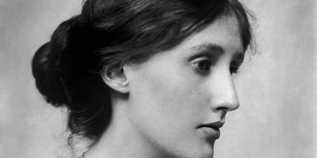 Black and white portrait of a woman with hair tied back, facing right in profile.