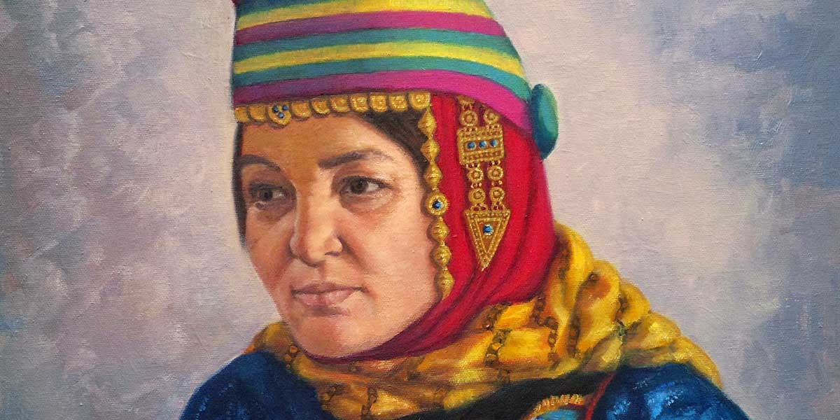 Portrait of a woman wearing a colorful striped hat, red scarf, and ornate gold jewelry.