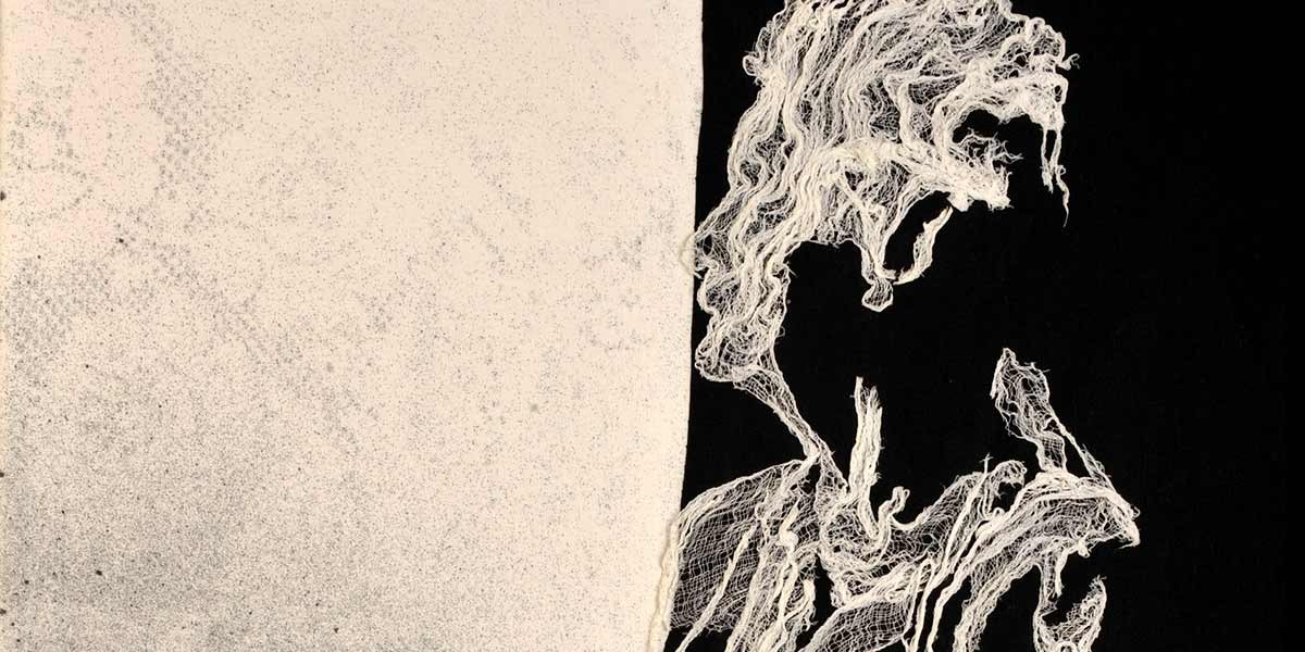Artistic lace silhouette of a person with flowing hair on a black and beige split background.