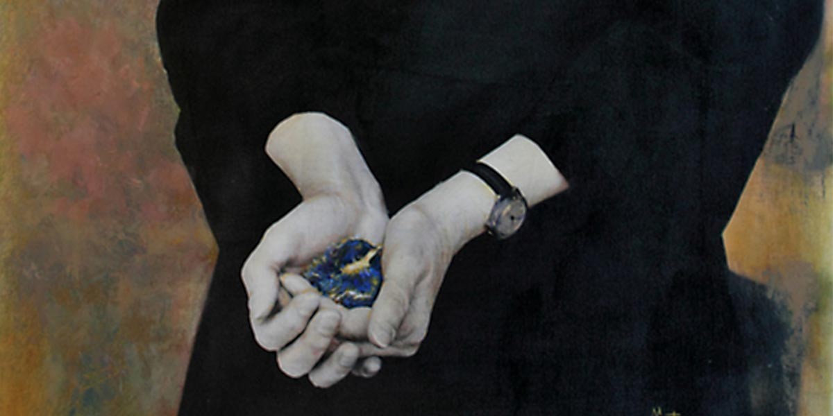 Person in black holding a small blue flower in cupped hands behind their back.