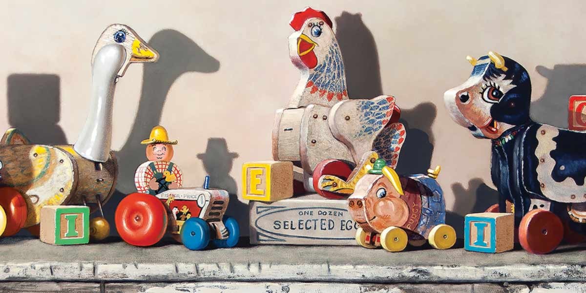 Row of vintage wooden pull toys shaped like a goose, farmer, chicken, duck, and cow with alphabet blocks.