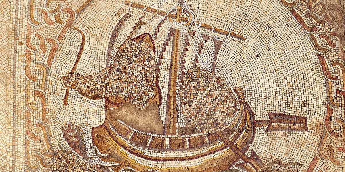Ancient mosaic of a ship with a sail and an animal figurehead holding a whip at the bow.