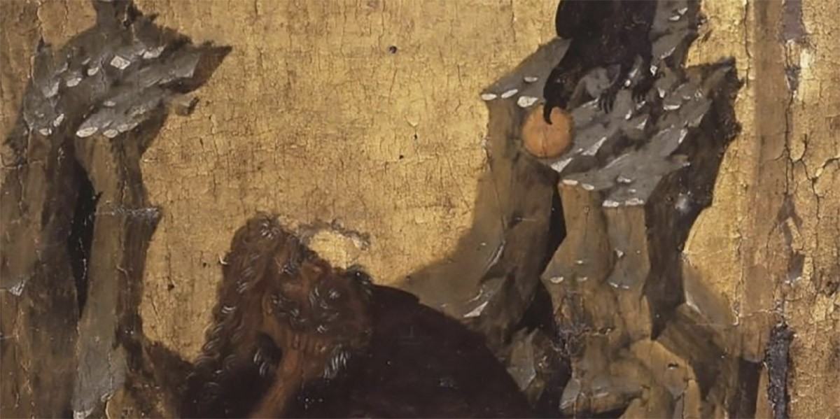 Dark-bearded figure seated under jagged rocks with a black bird perched holding a round object.