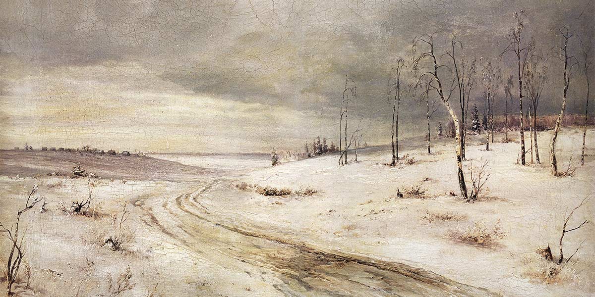 Snow-covered rural landscape with bare trees and a winding dirt path under a cloudy sky.