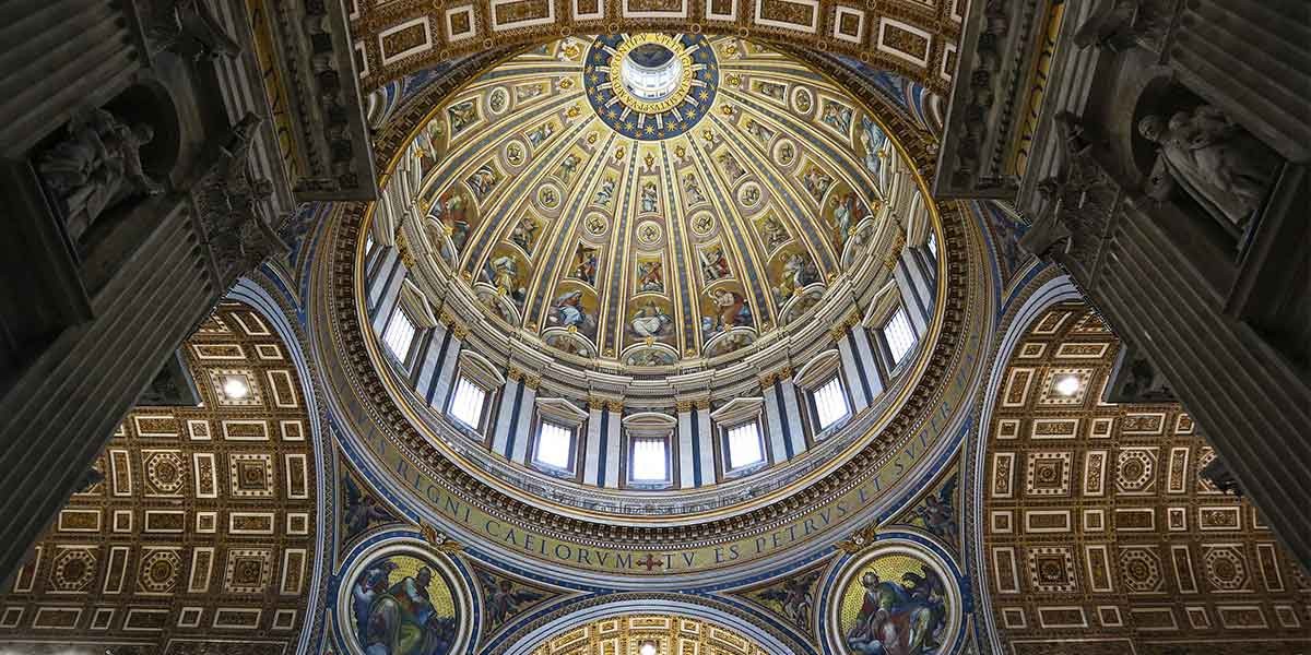 Ornate dome ceiling with painted religious figures and decorative gold patterns inside a church.