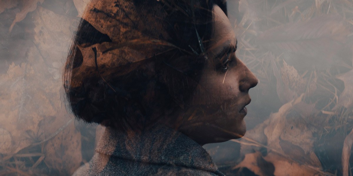 Double exposure of a woman’s profile blended with autumn leaves background.