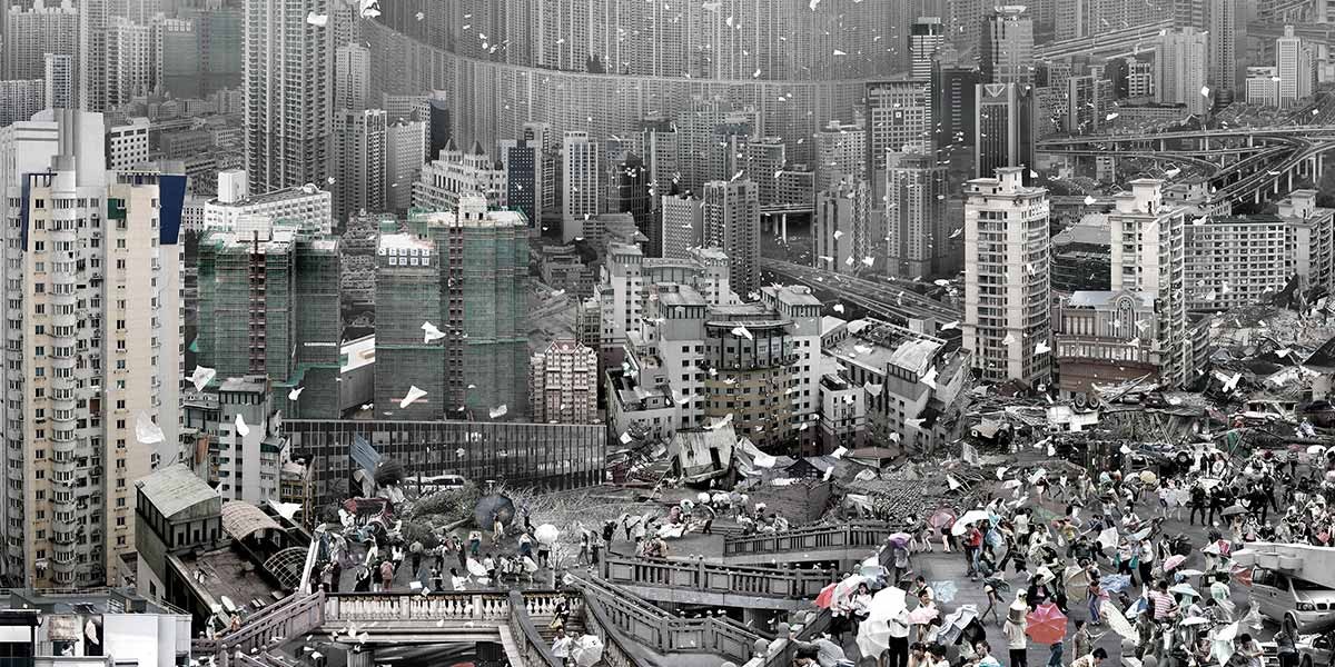 Crowded urban scene with numerous people holding umbrellas against backdrop of dense high-rise buildings.
