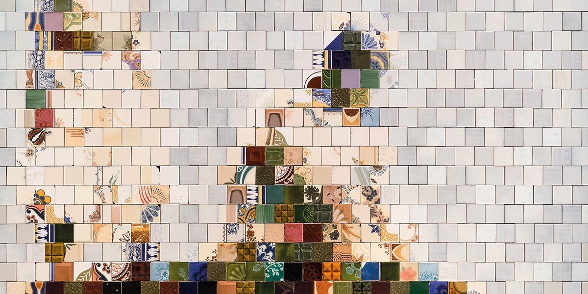 A mosaic of small square tiles creates an abstract dog figure on a neutral tile background.