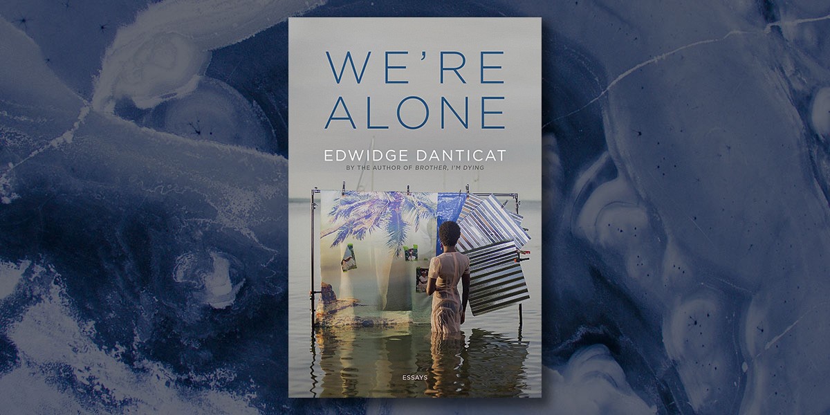 Book cover of We're Alone by Edwidge Danticat showing a woman standing in water behind hanging fabric.