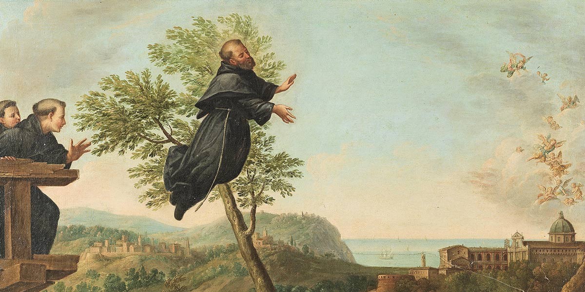 Monk in black robe levitates near tree with two monks watching from wooden balcony.