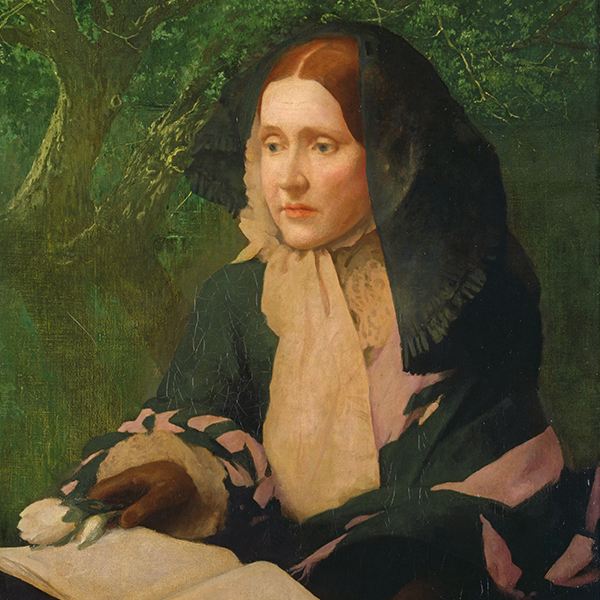 Portrait of a woman in historical clothing and a black shawl, seated outdoors near a tree.