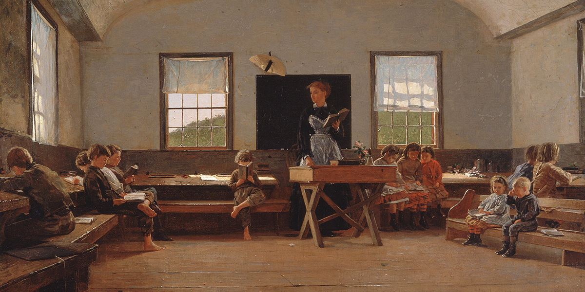 A teacher reading to children sitting on benches in a vintage classroom with wooden floors and windows.