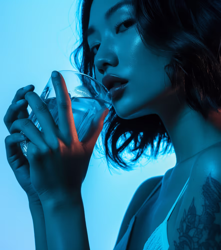 Creative silouette photo of an Asian woman standing against a gradient duck blue background, wearing a very tight white top that subtly reveals details underneath, her arm adorned with intricate Japanese-style tattoos.