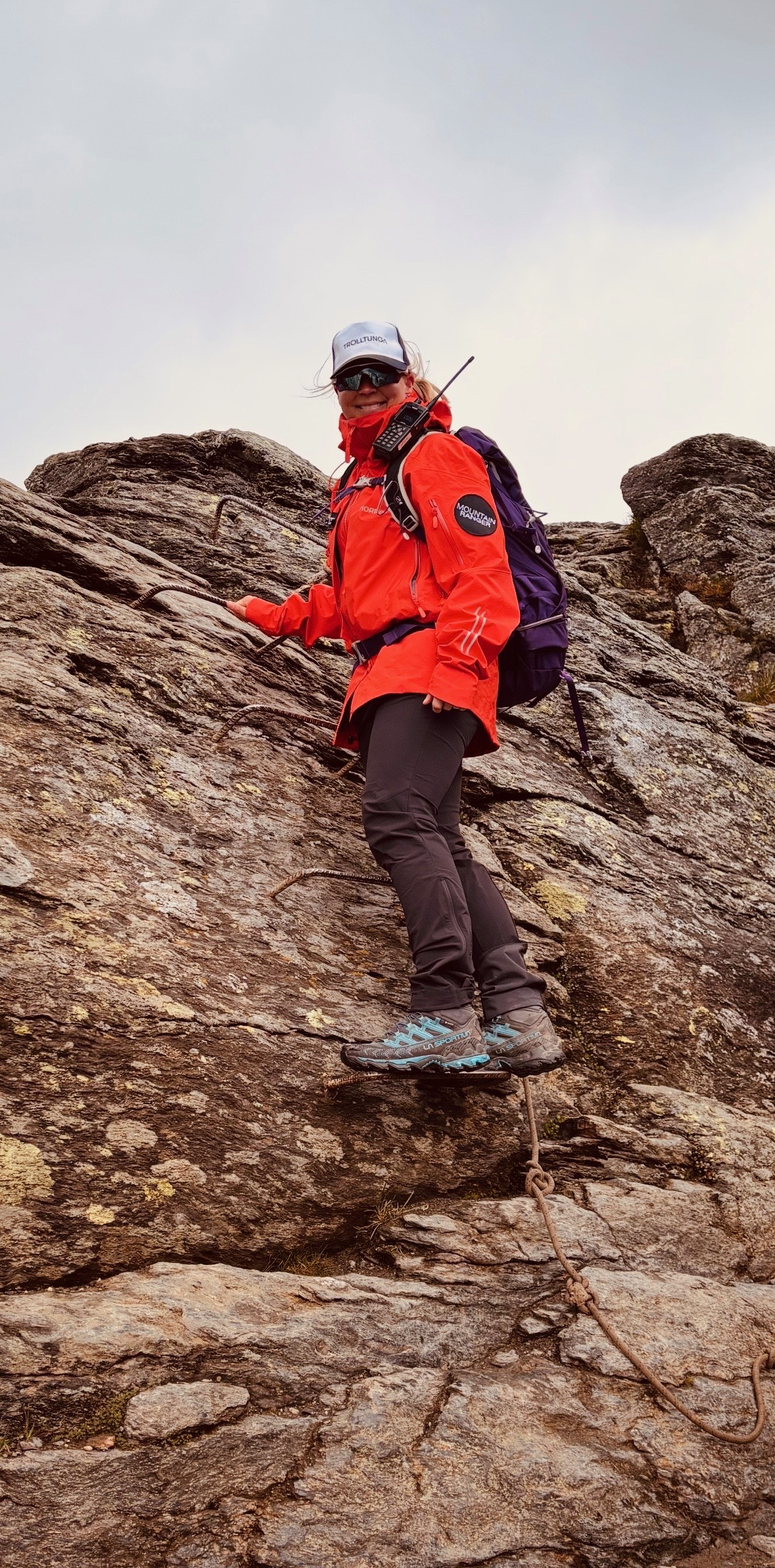 Mountain Ranger Karianne climbing the steep chained section on the Trolltunga trail