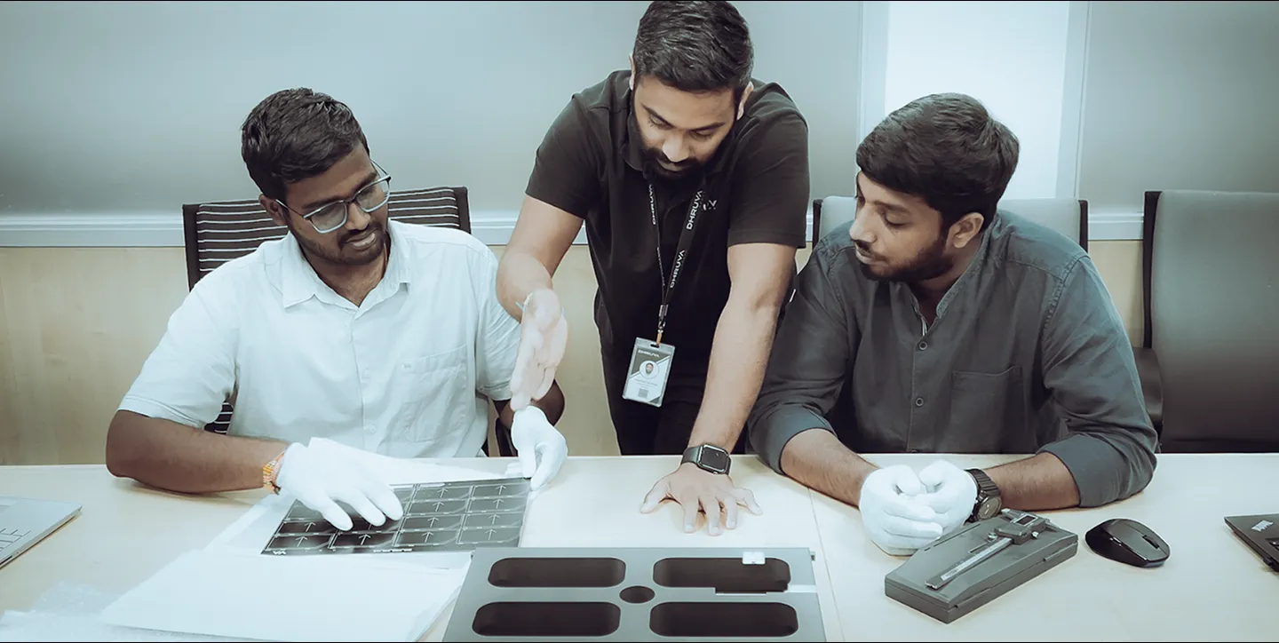 Employees working on solar panels at Dhruva Space.
