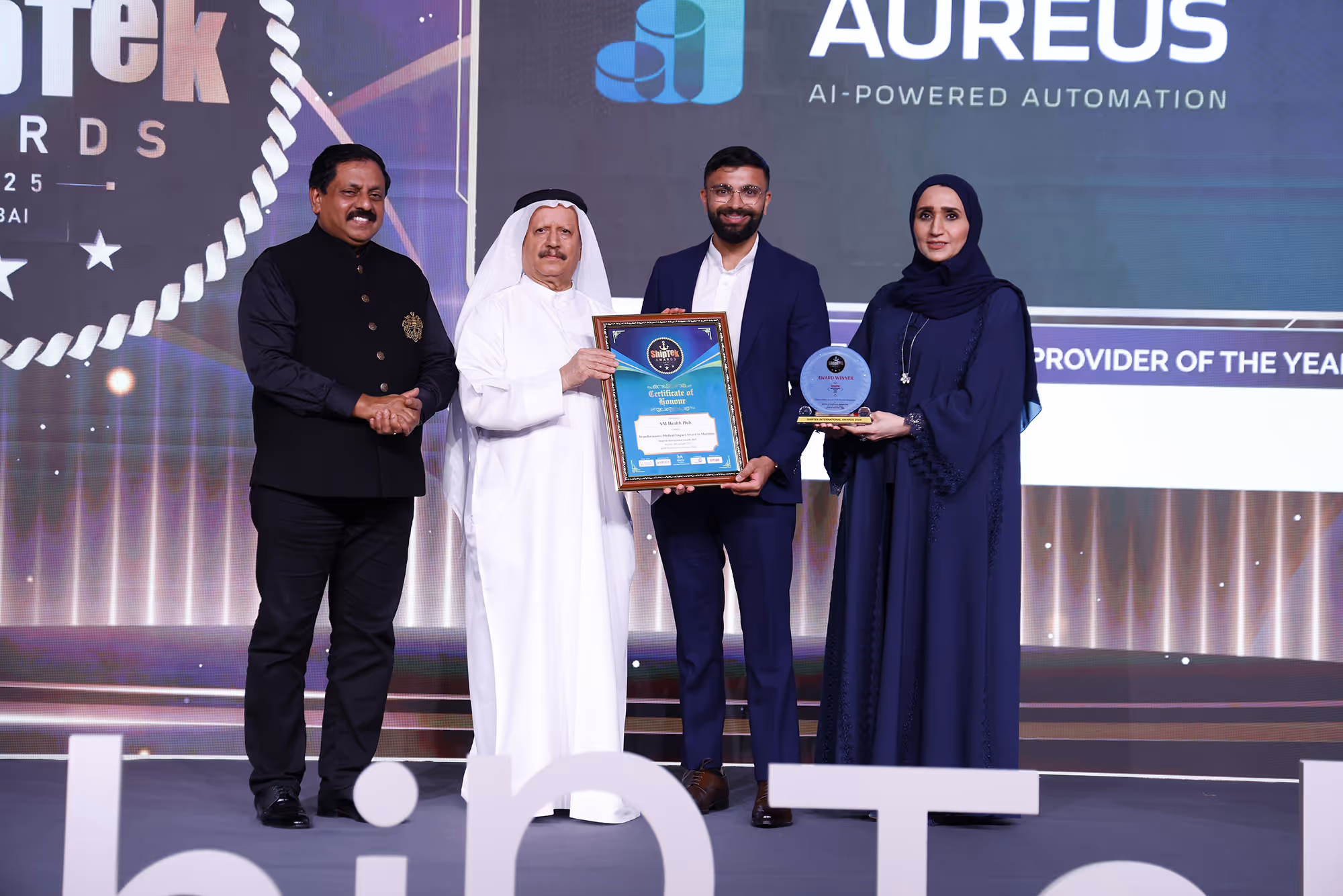 Engineers in a futuristic lab discussing artificial intelligence applications, with a large illuminated graphic of a brain and "AI" prominently displayed.