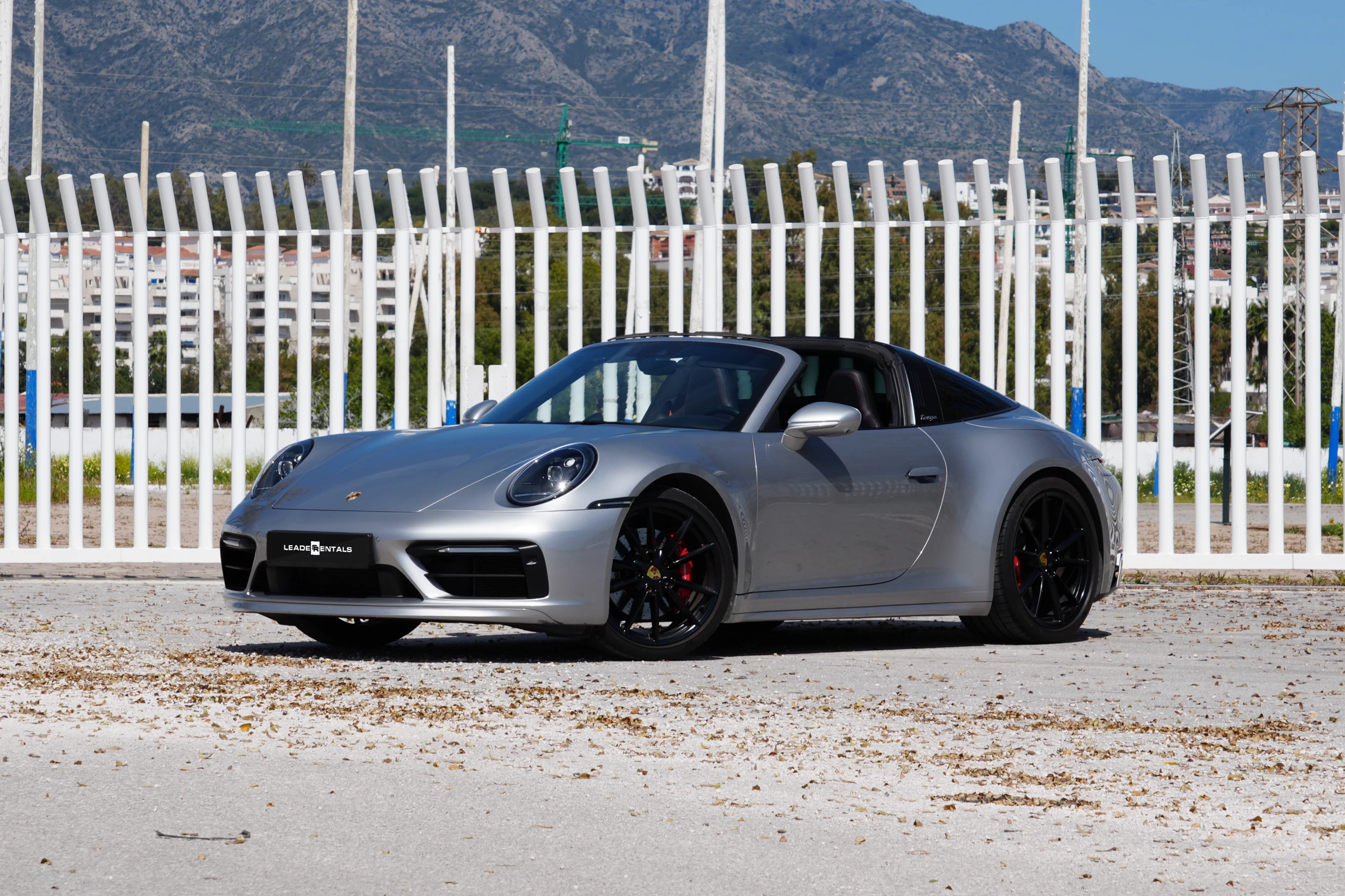 Experience open-top driving with the Porsche 911 Targa 4S (992) from Leader Rentals. Featuring a 450 hp twin-turbo flat-six and all-wheel drive, it sprints from 0–100 km/h in 3.8 seconds. The signature retractable Targa roof blends classic style with modern tech, delivering an iconic driving experience. Perfect for scenic routes, weekend escapes, and luxury touring across Europe.