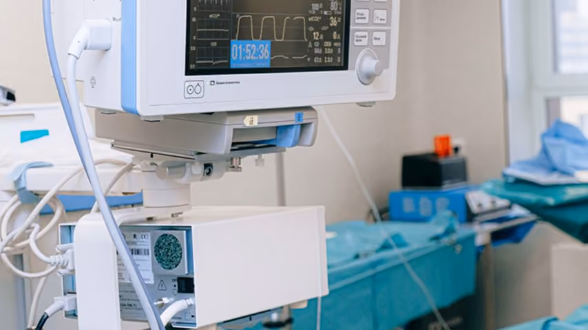 Patient vital signs monitor with digital readings in a clinical setting.
