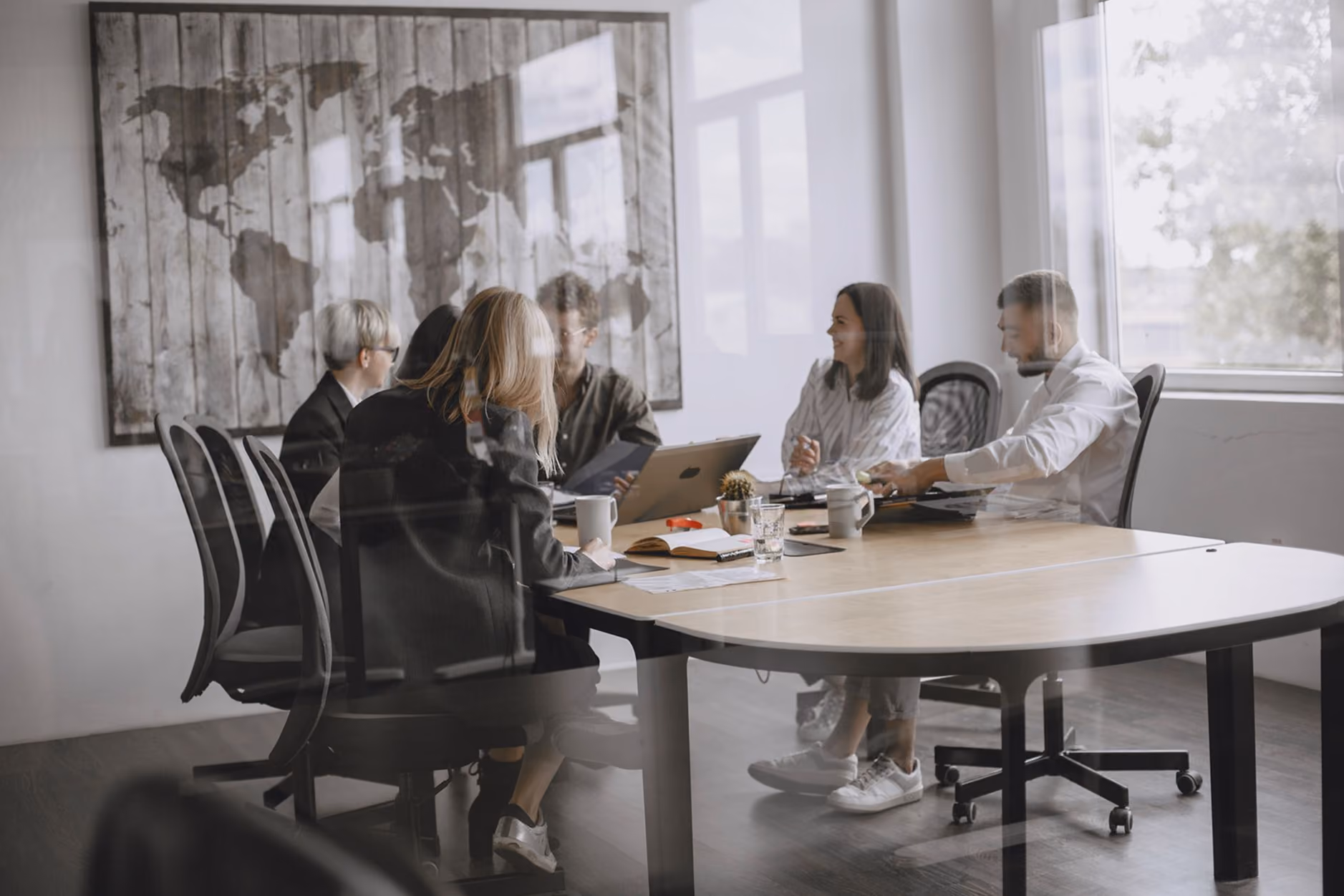 Team meeting inside meeting room, viewing from outside, through the glass