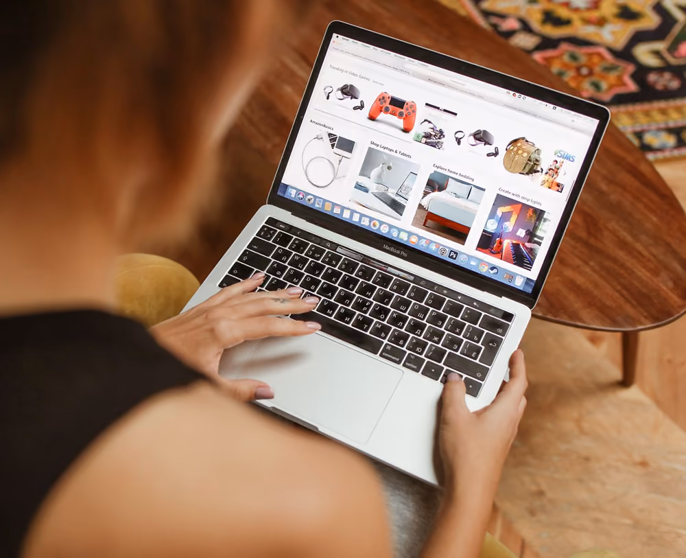 A woman using laptop, browsing an online marketplace
