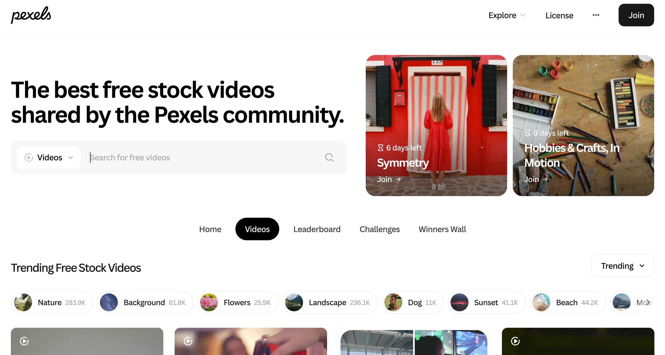 Pexels free stock video page with a search bar, community challenges like Symmetry and Hobbies and Crafts, and trending categories including Nature, Landscape, Sunset, and Beach