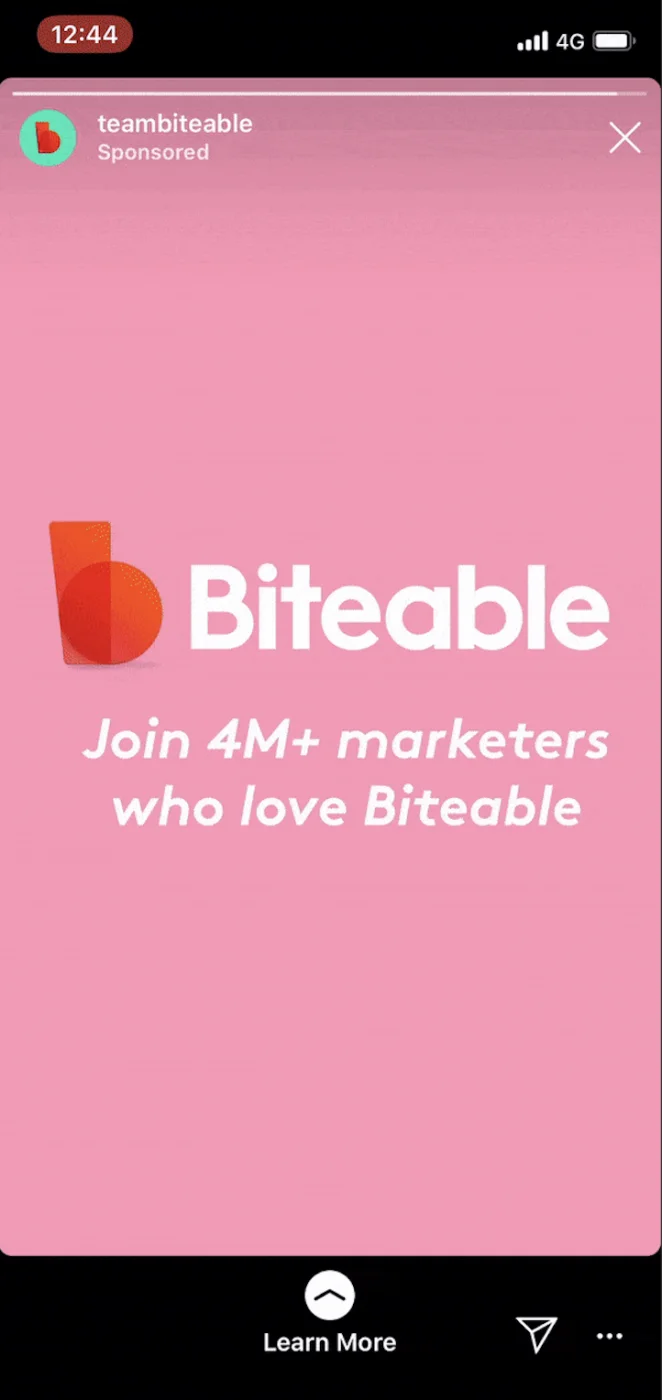 Biteable Instagram Story ad on pink background showing the Biteable logo (orange geometric 'b' shape) with white text reading 'Join 4M+ marketers who love Biteable.' Story displays sponsored label from @teambiteable with 'Learn More' swipe-up prompt at bottom