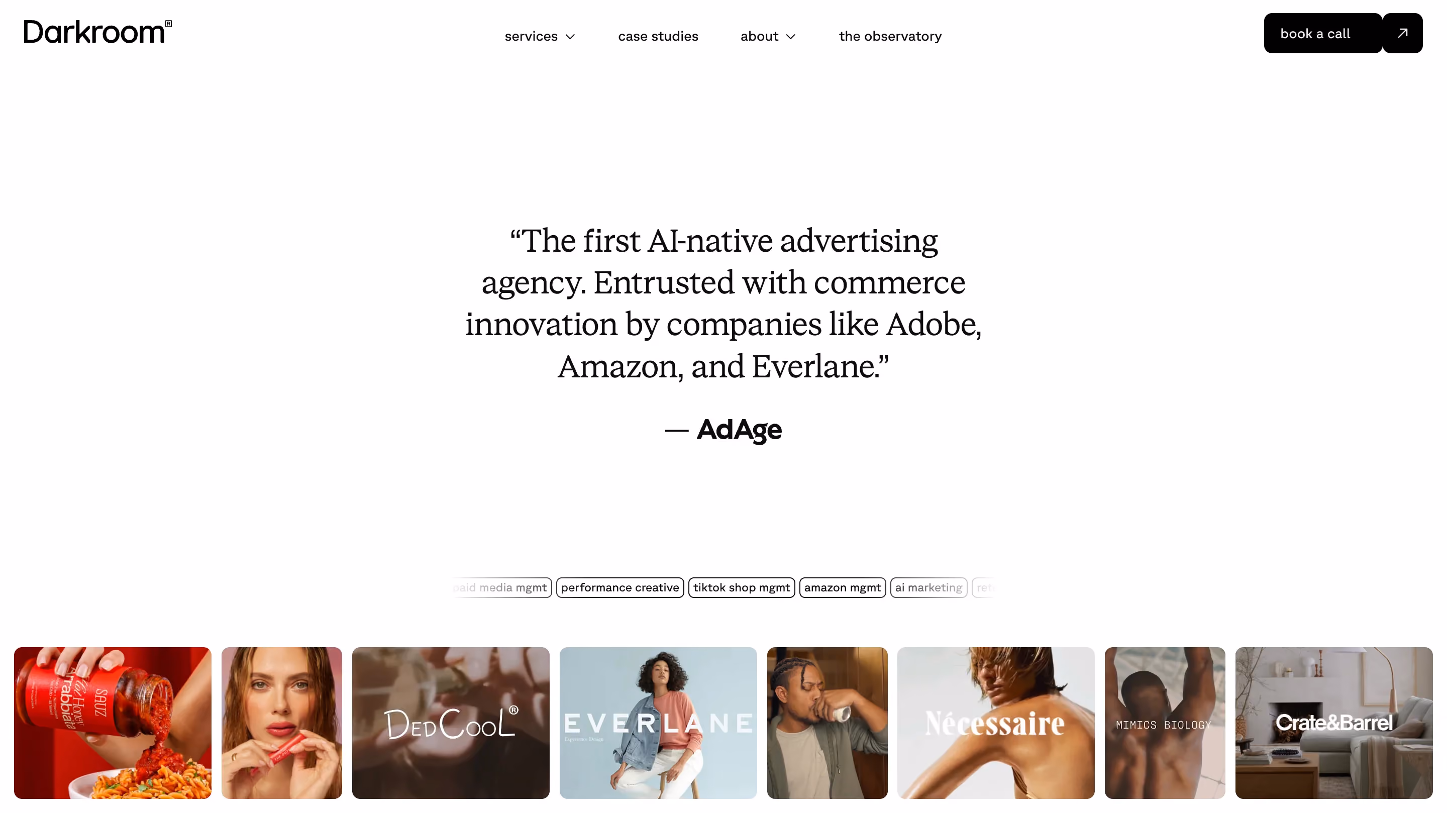 Darkroom performance creative agency website showing an AdAge quote describing them as "the first AI-native advertising agency" alongside a client campaign grid featuring brands including Adobe, Everlane, Necessaire, and Crate and Barrel