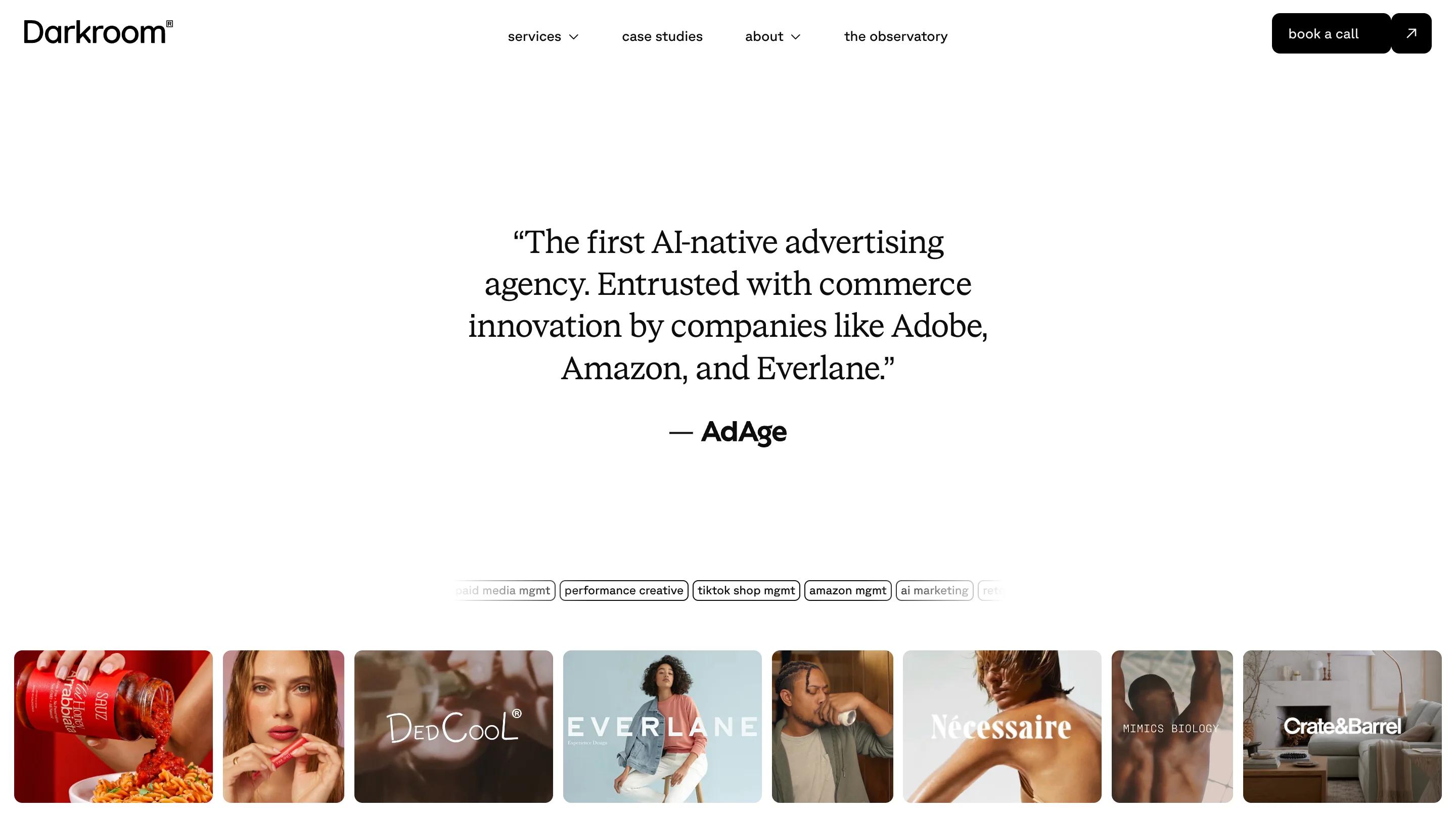 Darkroom performance creative agency website showing an AdAge quote describing them as "the first AI-native advertising agency" alongside a client campaign grid featuring brands including Adobe, Everlane, Necessaire, and Crate and Barrel
