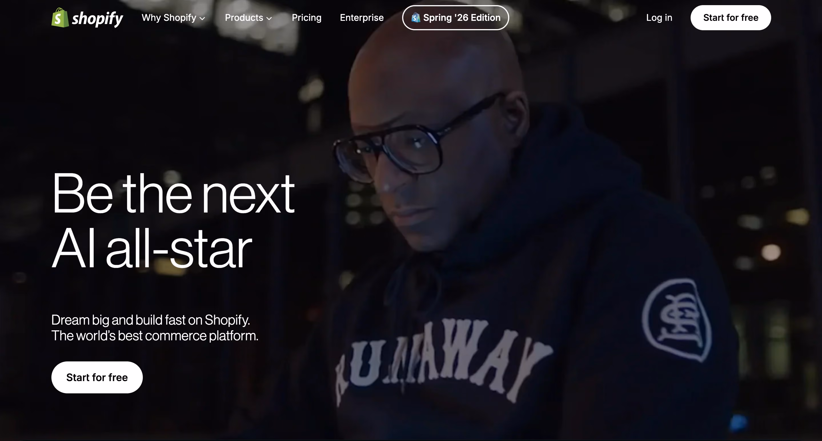 homepage of shopify website showing a man with glasses