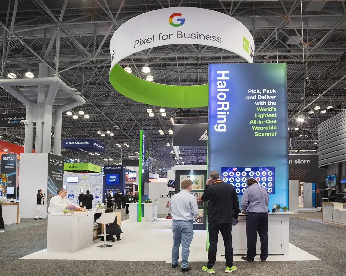 Google Pixel for Business trade show booth with a hanging ring sign and a tall HaloRing tower with a screen and counters
