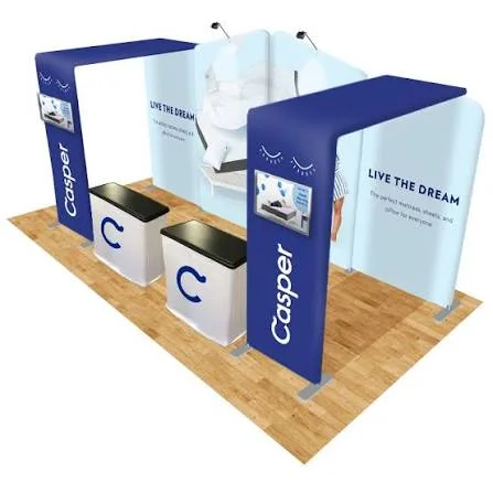 3D render of a Casper trade show booth with two blue fabric arches, white counters, and a Live the dream back wall