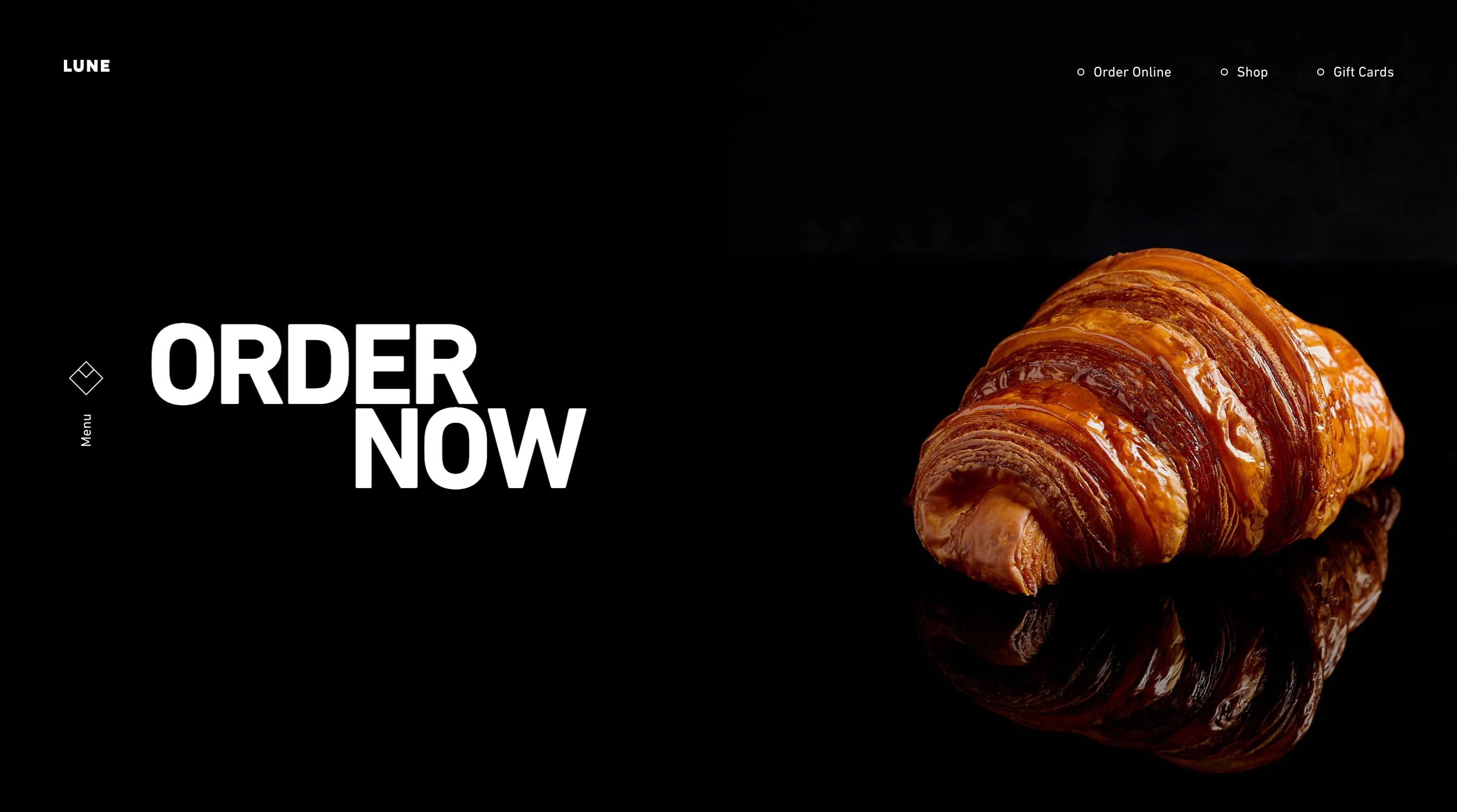 Lune homepage on black with a large ORDER NOW heading, a glossy croissant, and Order Online, Shop, and Gift Cards links