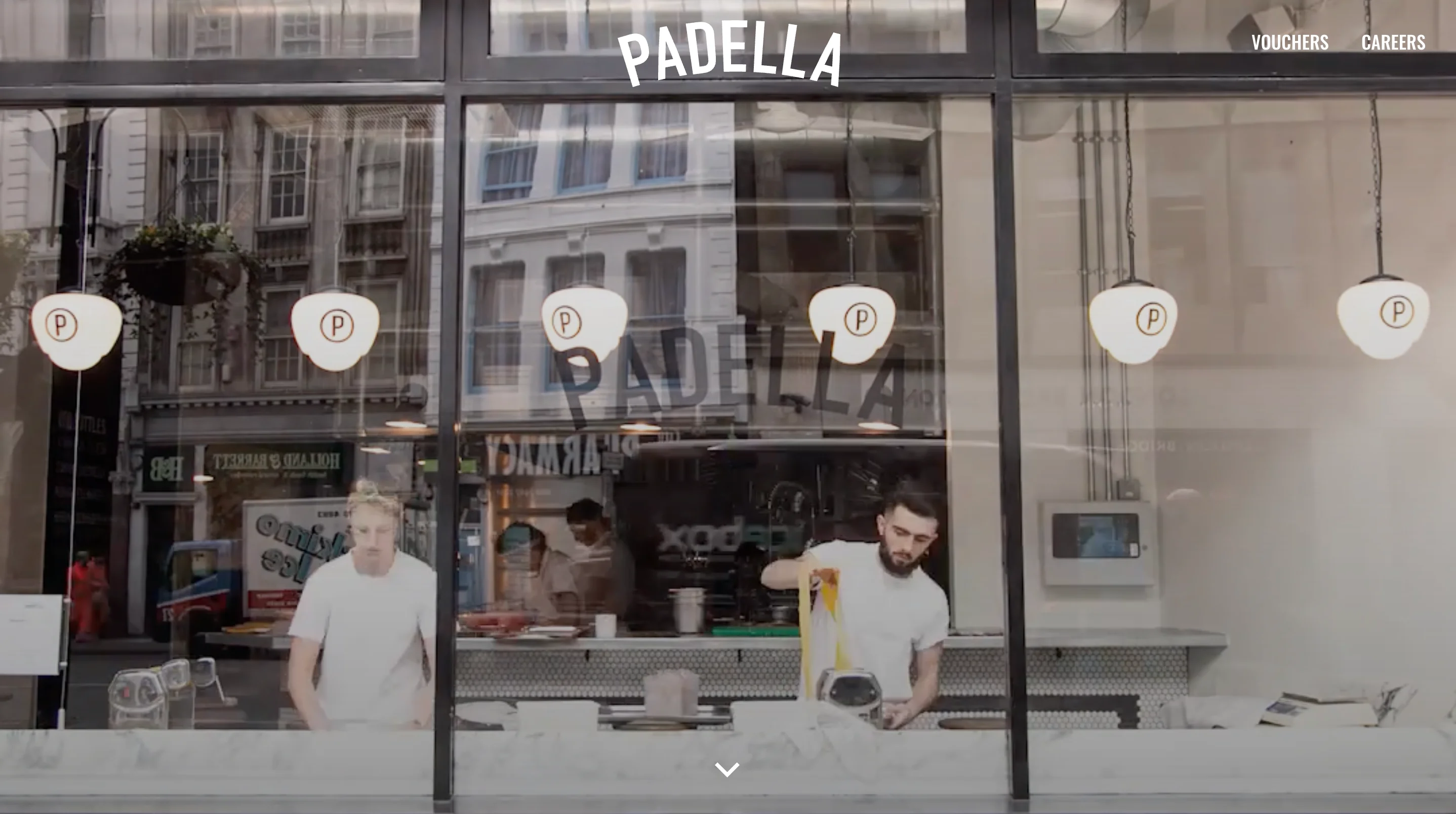 Padella homepage hero showing two cooks making pasta behind the restaurant's glass window, with Vouchers and Careers links