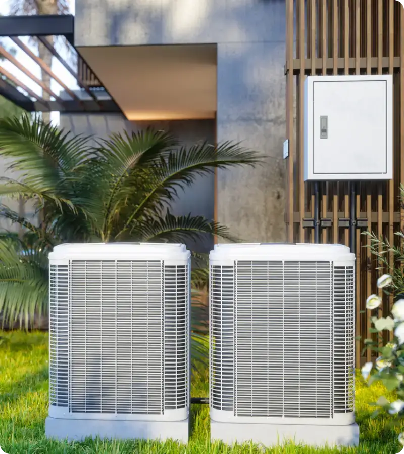 A modern, energy-efficient outdoor air conditioning condenser unit installed on a level pad A modern, energy-efficient outdoor air conditioning condenser unit installed on a level pad