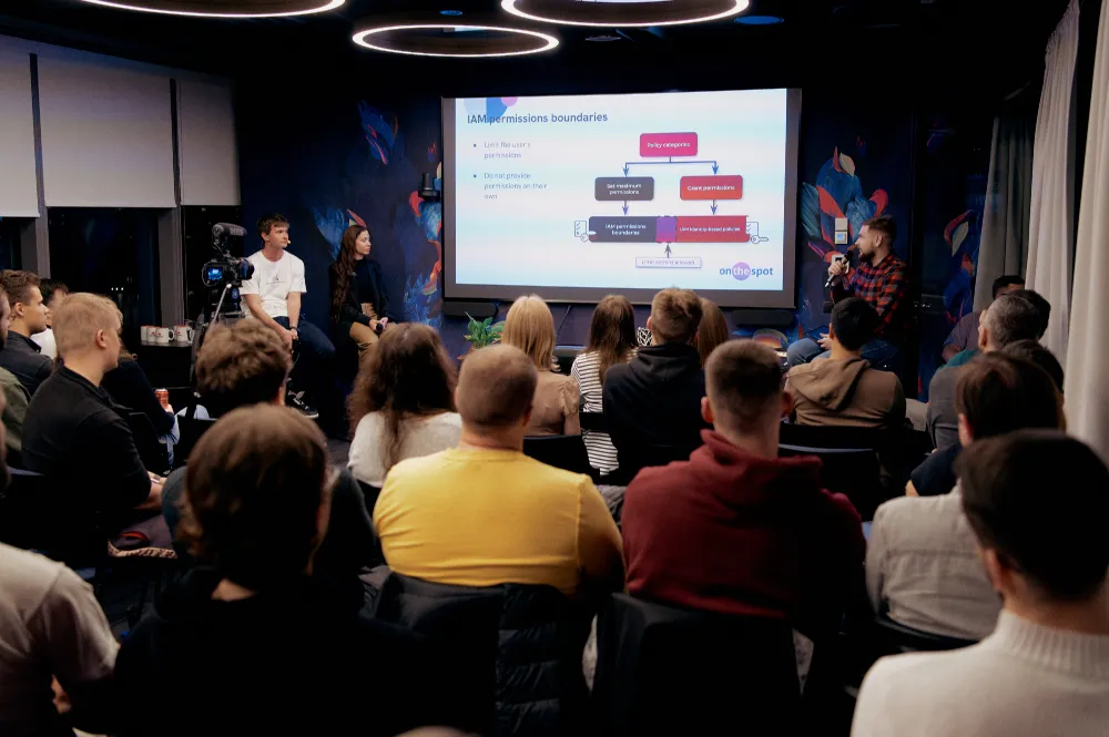 Audience watching a slide presentation at Cloud focused meetup