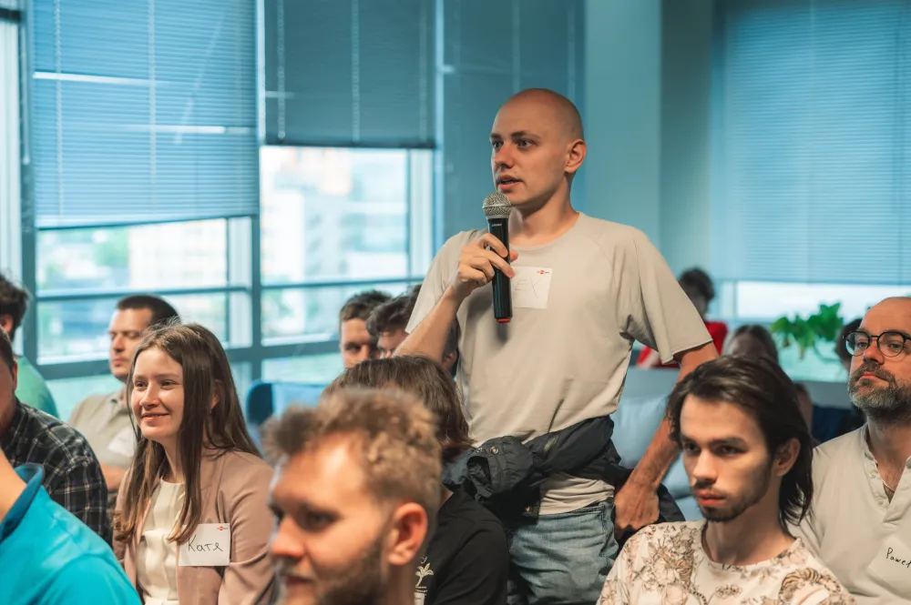A guest asking a question with a microphone at eBPF & observability TechSpot